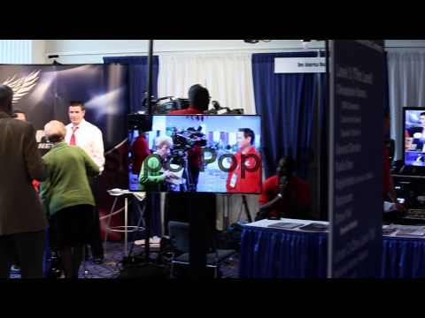 Crew members of One America News Network work at their bo…