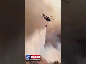 Nevada National Guard helicopter dropped water on the fast-moving Hawk Fire northwest of Reno