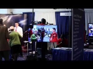Crew members of One America News Network work at their bo…