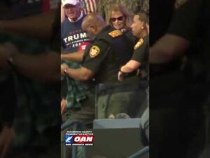 Deputies escort a protester out of President Trump’s rally